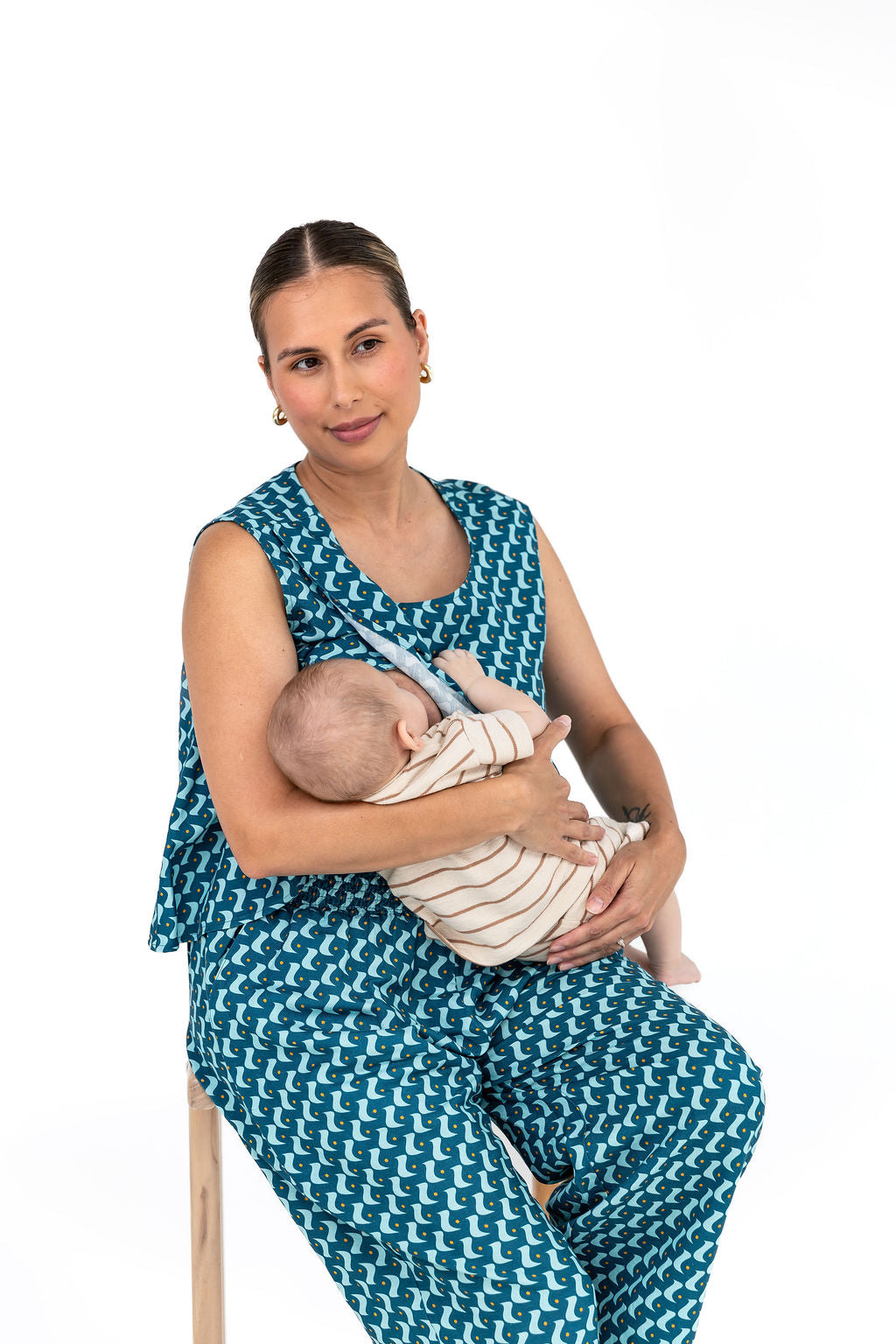 Mums with their babies sitting on a couch. All are wearing Saturday Vibes - bump and breastfeeding friendly clothing.