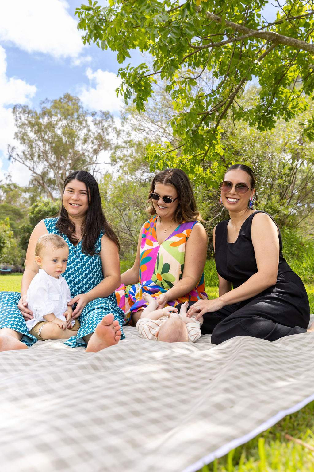 The mums wearing Saturday Vibes. Sitting on picnic rug.